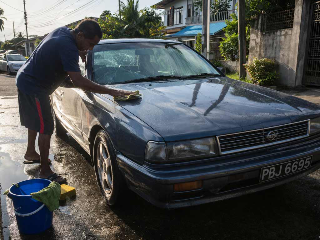 man-washing-car-at-sunrise