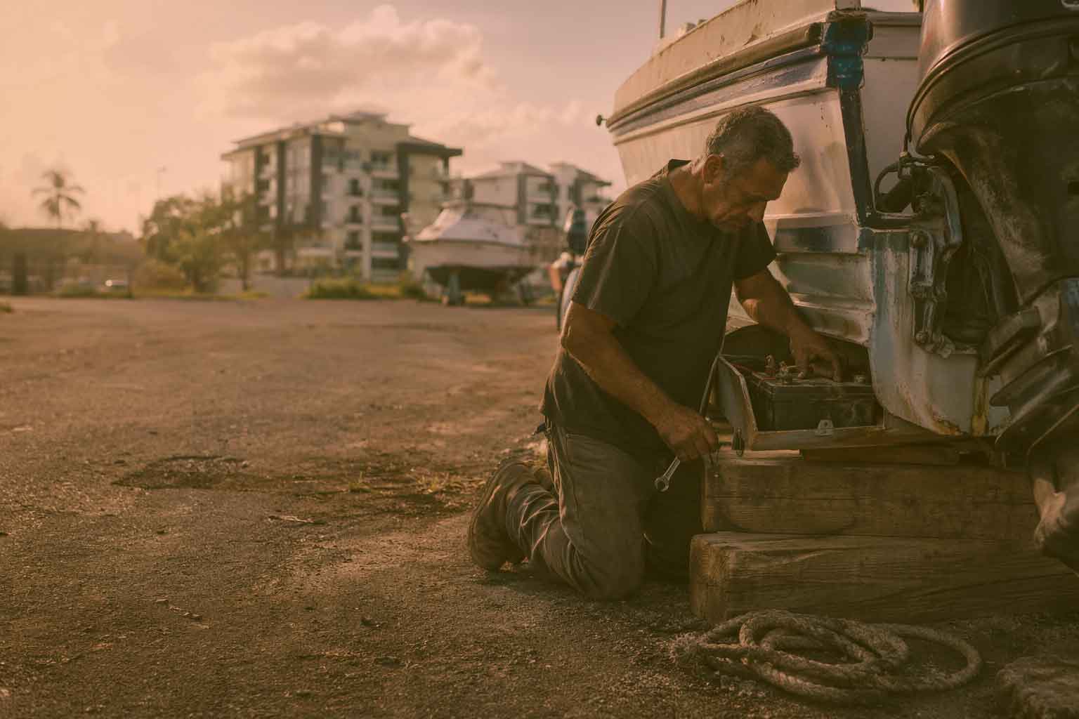 man fixing a boat on marina